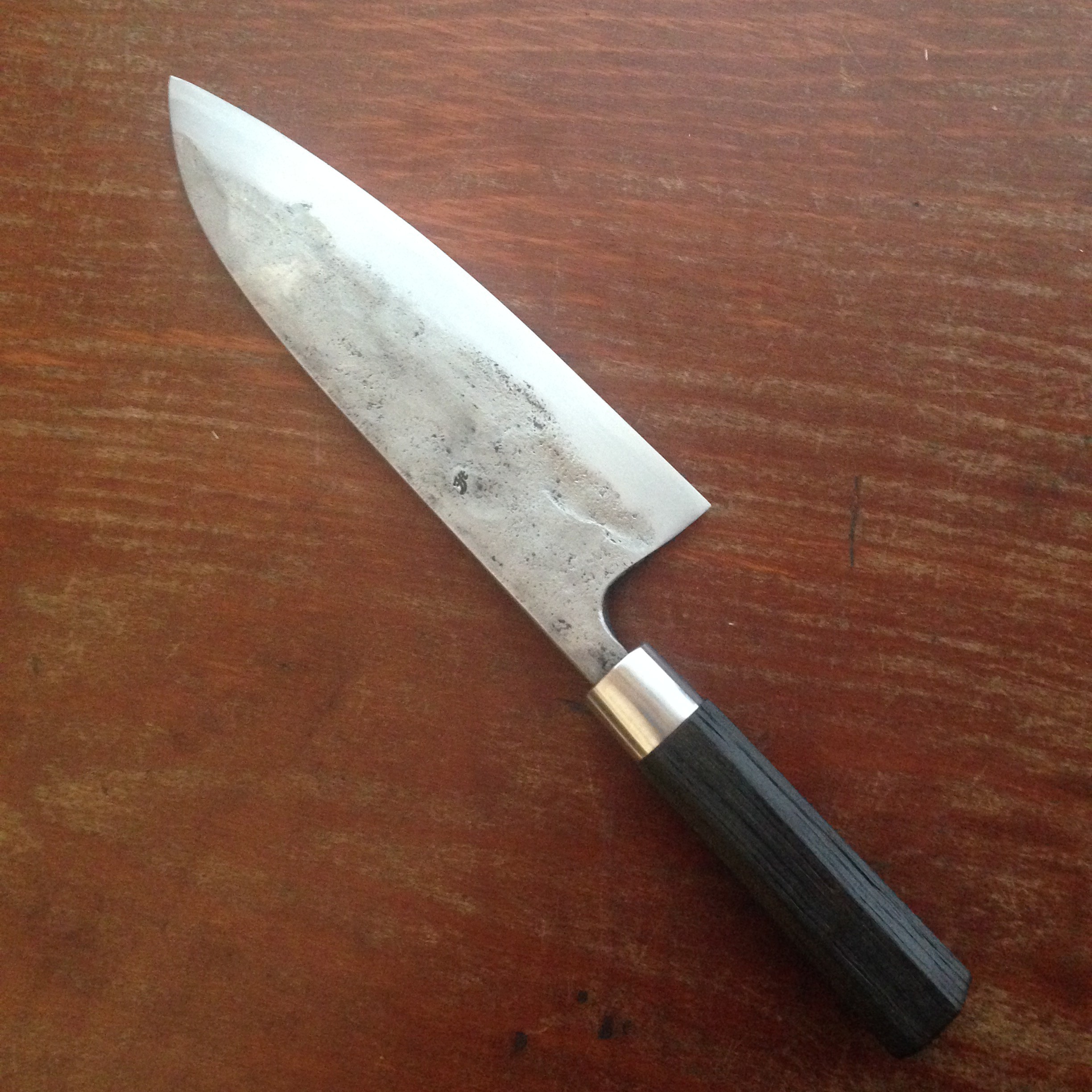 Deba with a san-mai blade steel ferrule and black bog oak. Cutting edge/ core is 1.2516.